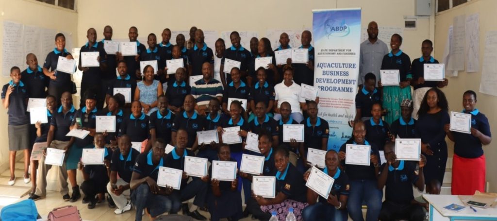 Cage beneficiaries from five riparian counties displaying Certificates of Participation at the conclusion of the GALS HHM capacity building at RCO, Kisumu.